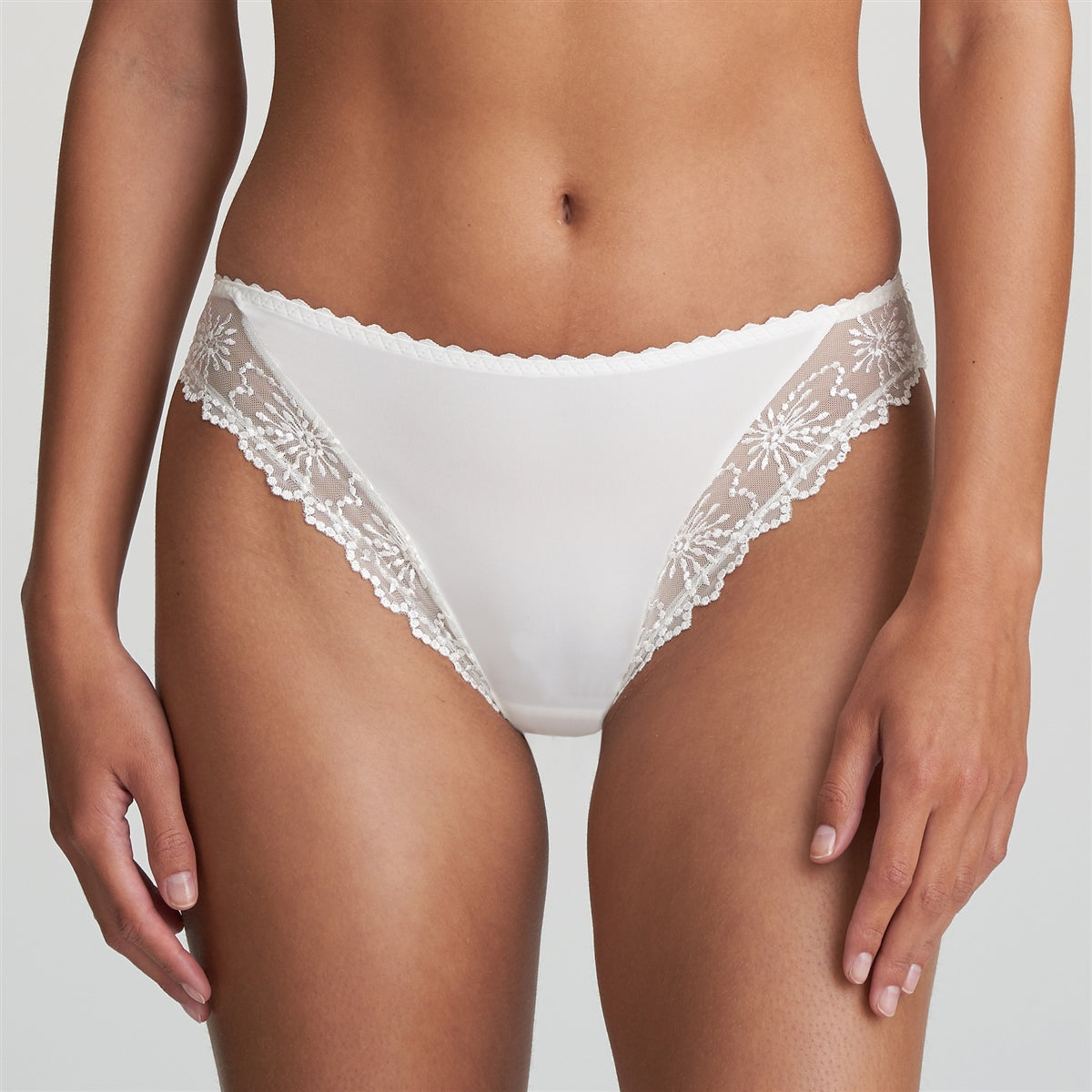 Playful and feminine ivory bikini brief with lace embroidery.