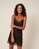Beautiful black silk chemise featuring a delicate lace trim and a band of tulle that highlights the neckline
