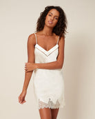 Beautiful ivory silk chemise featuring a delicate lace trim and a band of tulle that highlights the neckline