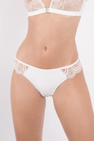 Ivory tanga featuring opaque centre and fine lace sides with graphic embroidery