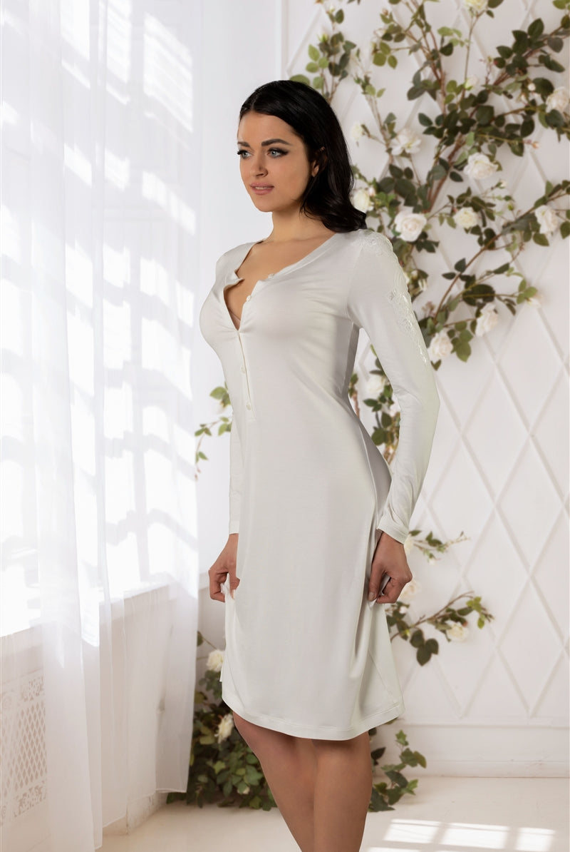 Ivory long sleeve nightdress made from a soft viscose fabric featuring buttons at front centre and lace embroidery on sleeves. Length sits above the knees.