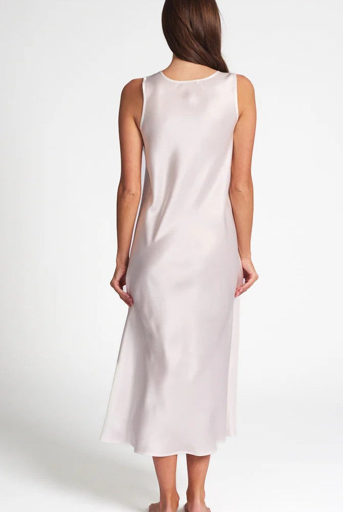 Woman wearing a white sleeveless dress on a white background