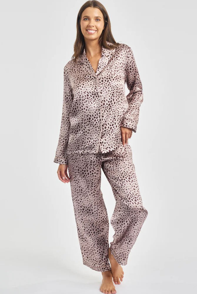 Woman wearing a patterned pajama set on a white background
