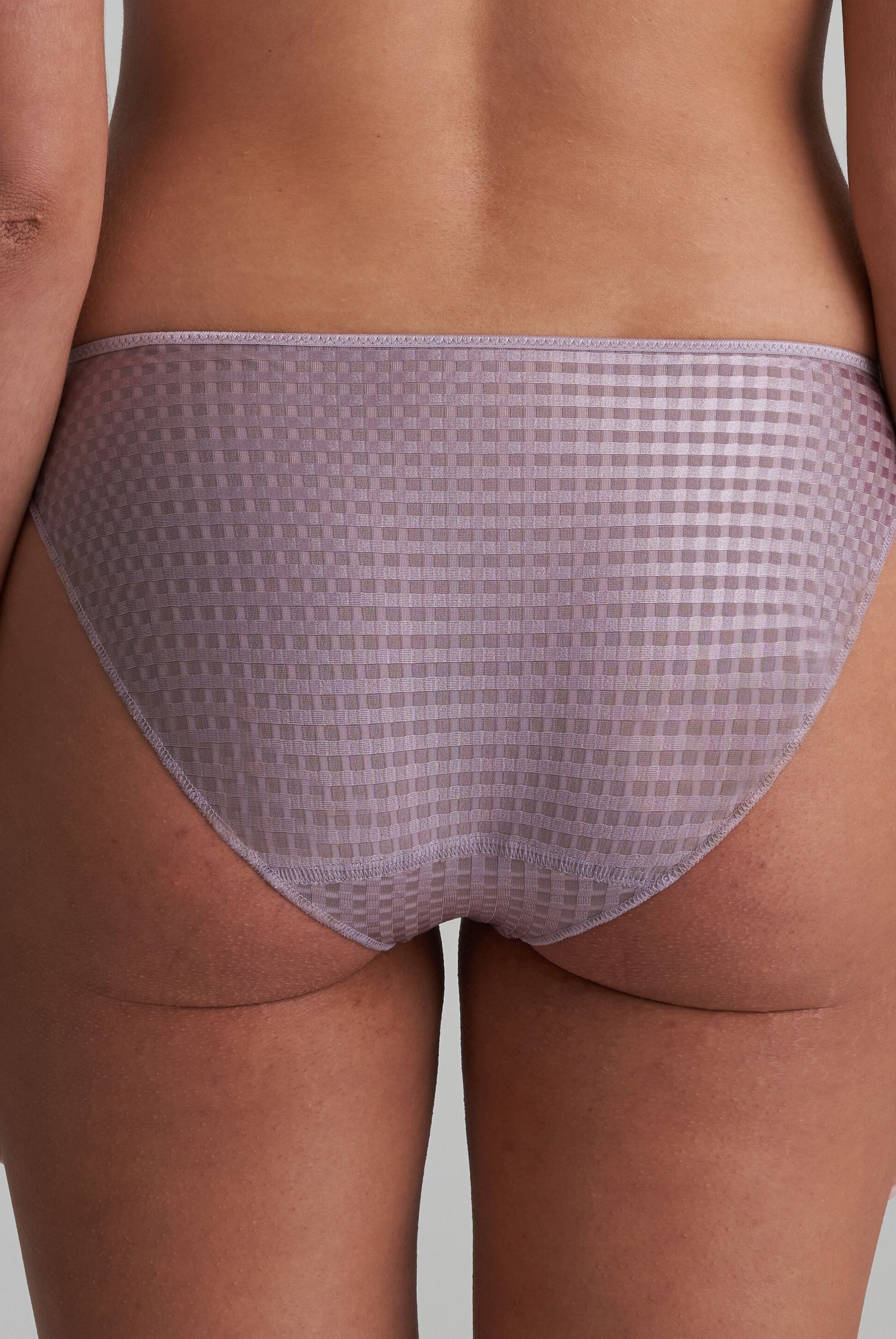 Back of briefs in a soft sand colour that are decorated with a floral embroidery