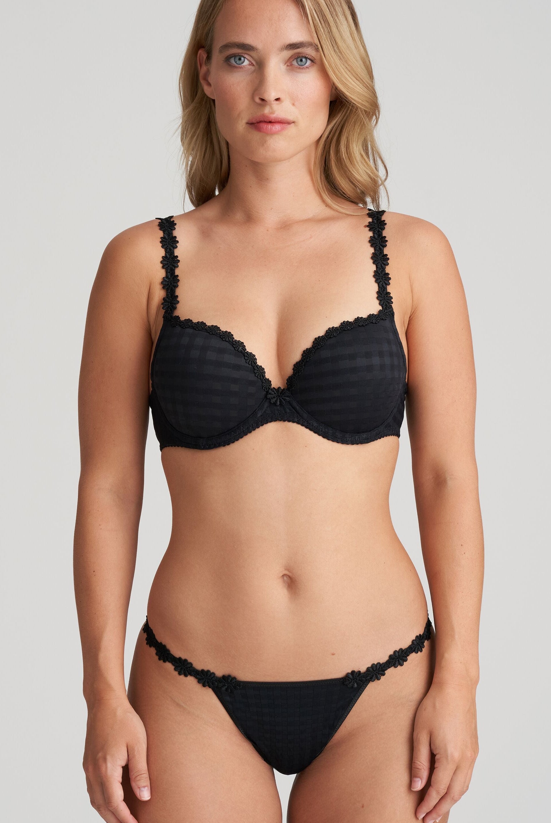 Black thong that is non transparent in front and features delicate floral embroidery soft waistband with matching bra.