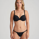 Black thong that is non transparent in front and features delicate floral embroidery soft waistband with matching bra.