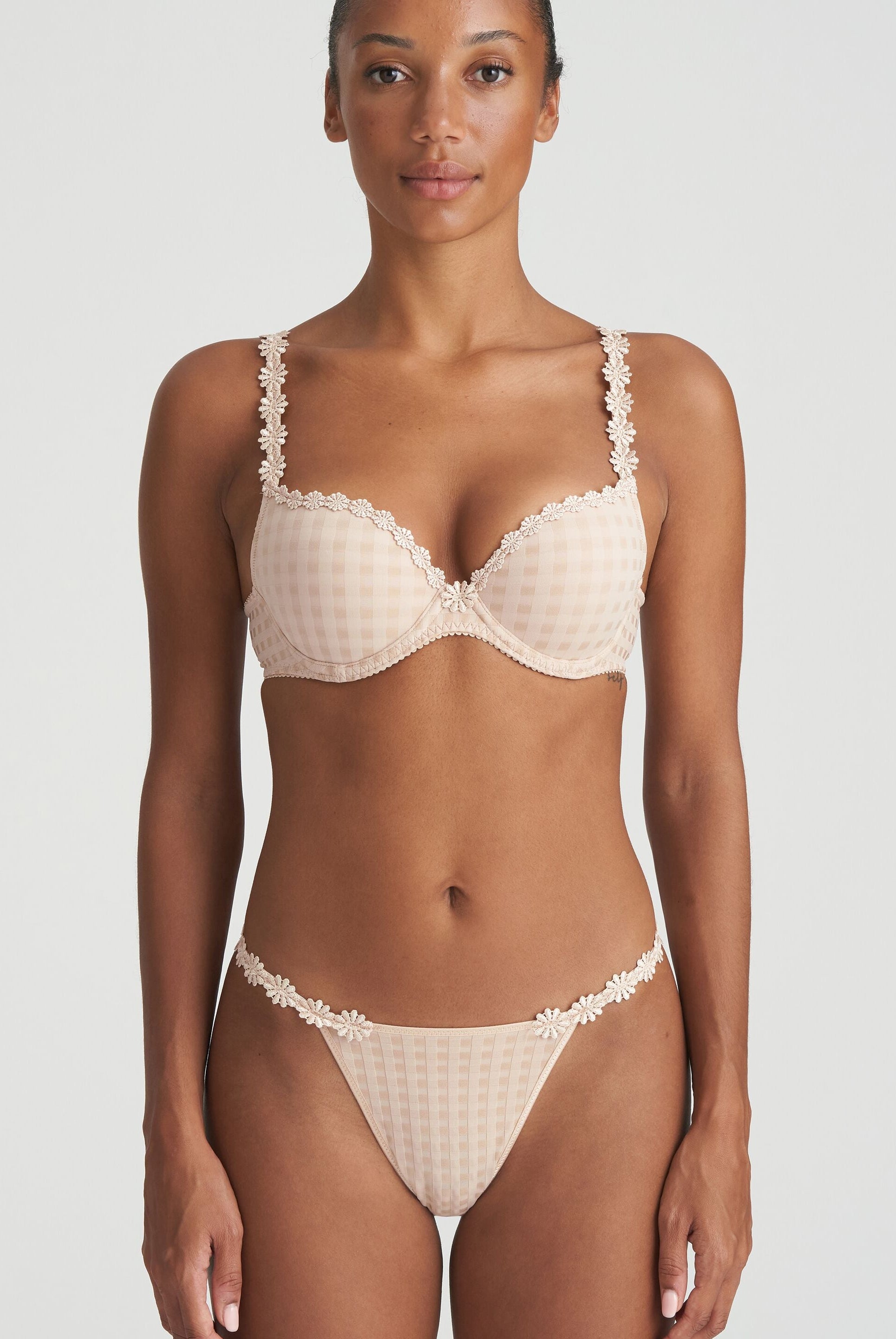 Neutral thong that is non transparent in front and features delicate floral embroidery soft waistband with matching bra.