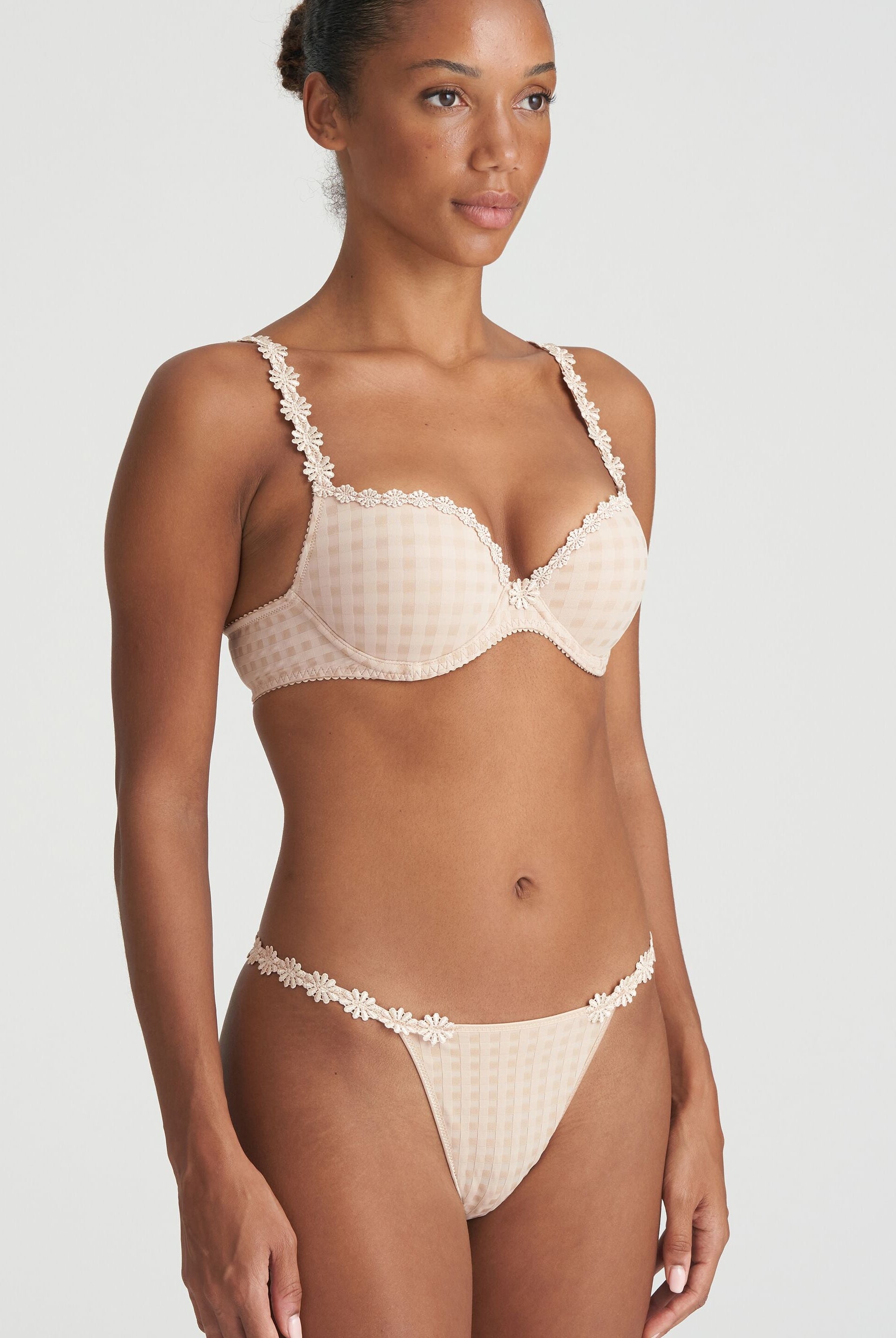 Neutral thong that is non transparent in front and features delicate floral embroidery soft waistband with matching bra.