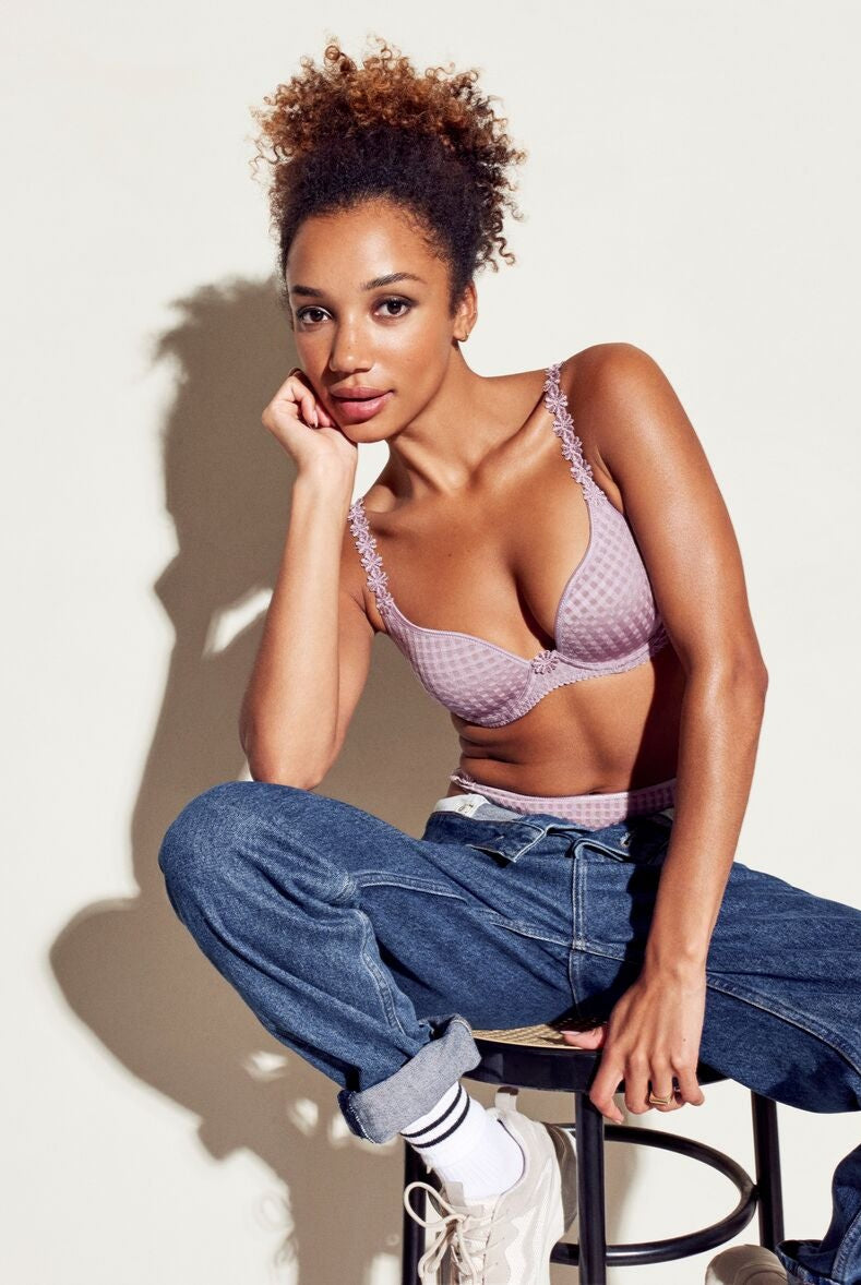 Soft sand padded bra featuring heart-shaped cups, underwire and multi-way straps pictured with jeans