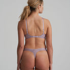 Back view of thong in soft sand colour with little flower at back and shimmer to the fabric and matching bra