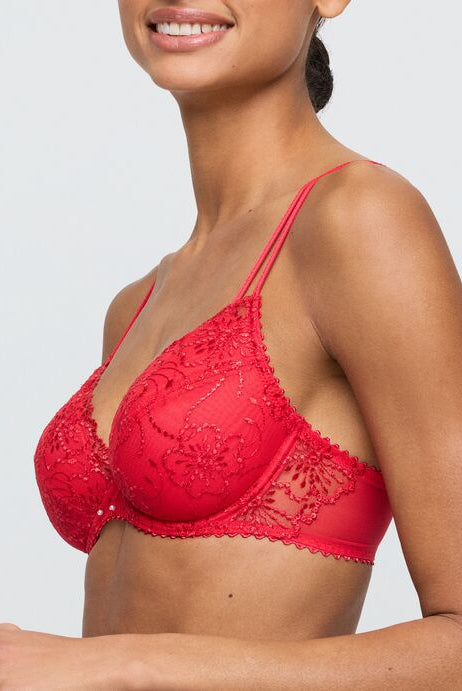 Red lace bra worn by a model on a plain background