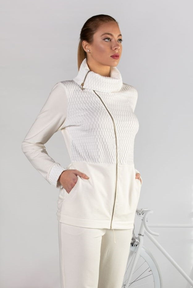 Elegant top crafted from luxuriously soft fabrics which feature a zip, pockets at the sides, wrap around doubled high neck and drawstring at the back.