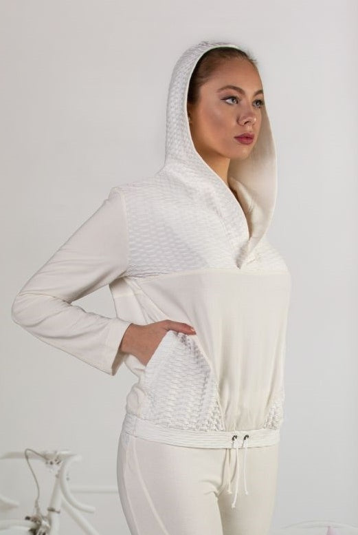 Elegant hooded sweater crafted from luxuriously soft fabrics featuring a diagonal pouch cut and drawstring at the waist