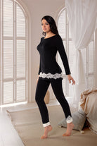 Black long sleeve pyjama top with ivory lace detail . Matching black leggings with ivory lace detail.