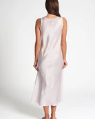 Woman wearing a white sleeveless dress on a white background