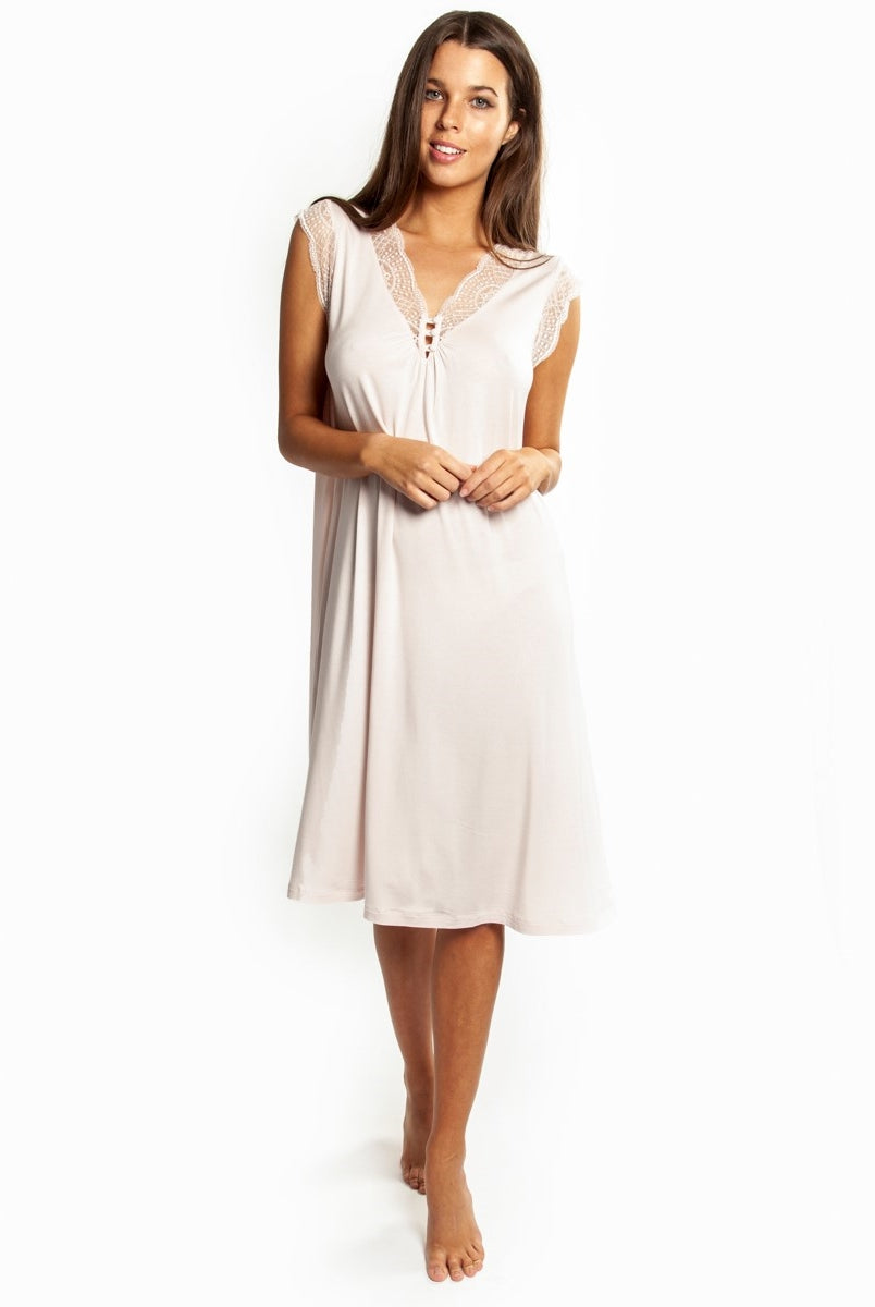 Pale pink modal nightdress featuring French Leavers lace on the front with button detail. Length sits just below the knee.