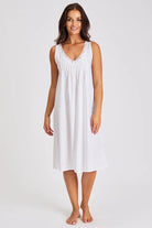 White cotton nightie featuring a delicate lace trim that decorates the neckline with flat shoulder straps