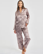 Woman wearing a patterned pajama set on a white background