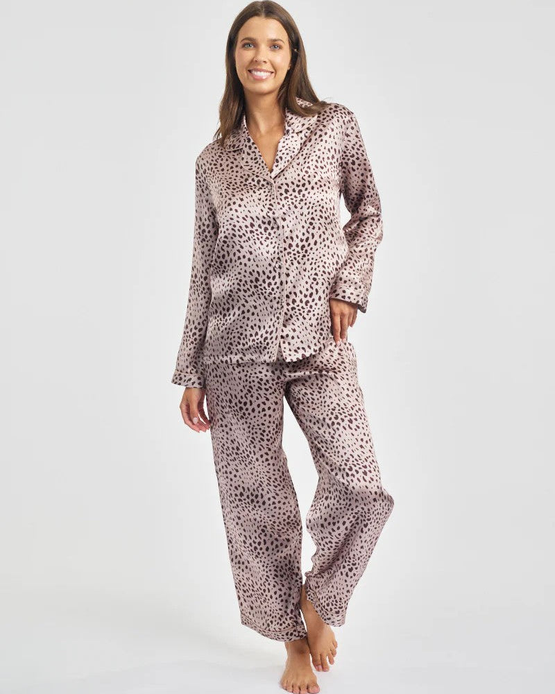 Woman wearing a patterned pajama set on a white background