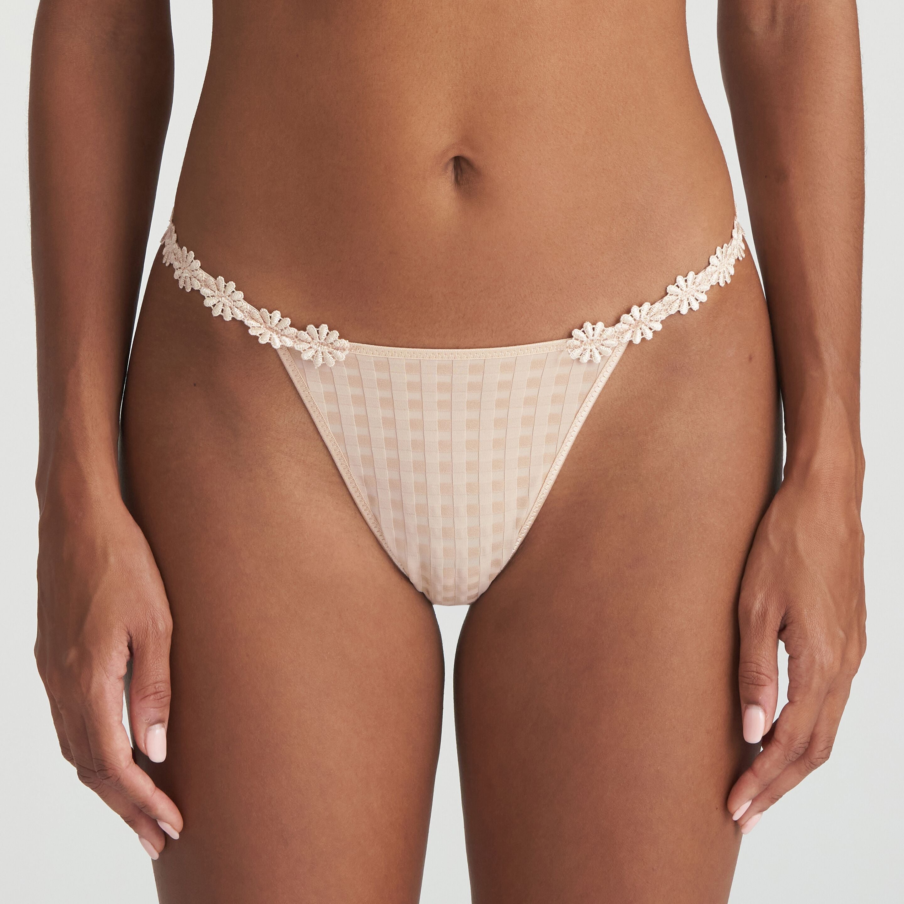 Neutral thong that is non transparent in front and features delicate floral embroidery soft waistband.