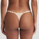 Back of Neutral thong that is non transparent in front and features delicate floral embroidery soft waistband.