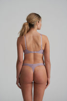 Back view of thong in soft sand colour with little flower at back and shimmer to the fabric and matching bra