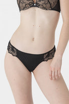 Black tanga brief with front in opaque mesh and back featuring floral embroidery