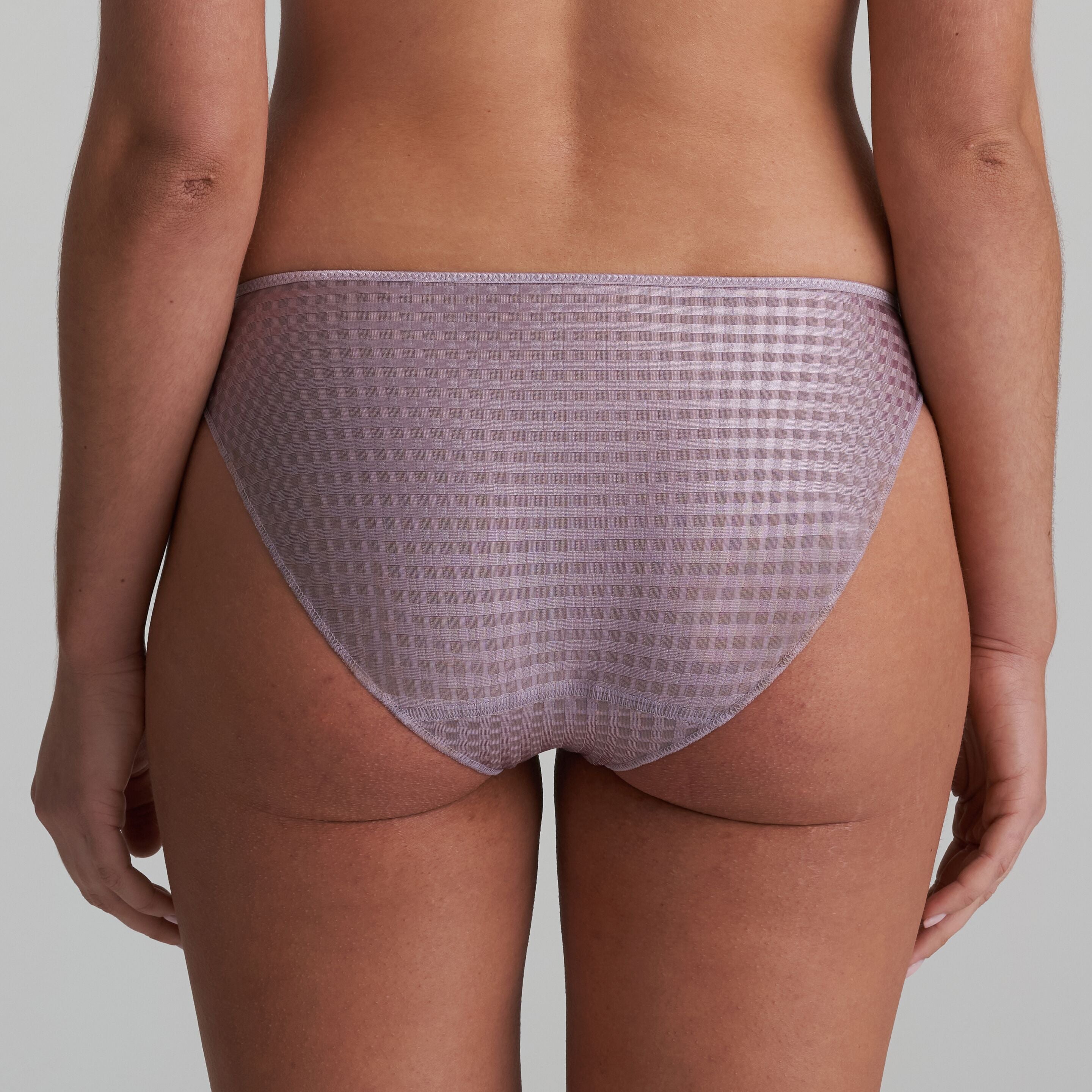 Back of briefs in a soft sand colour that are decorated with a floral embroidery
