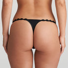 Back of black thong that is non transparent in front and features delicate floral embroidery soft waistband.