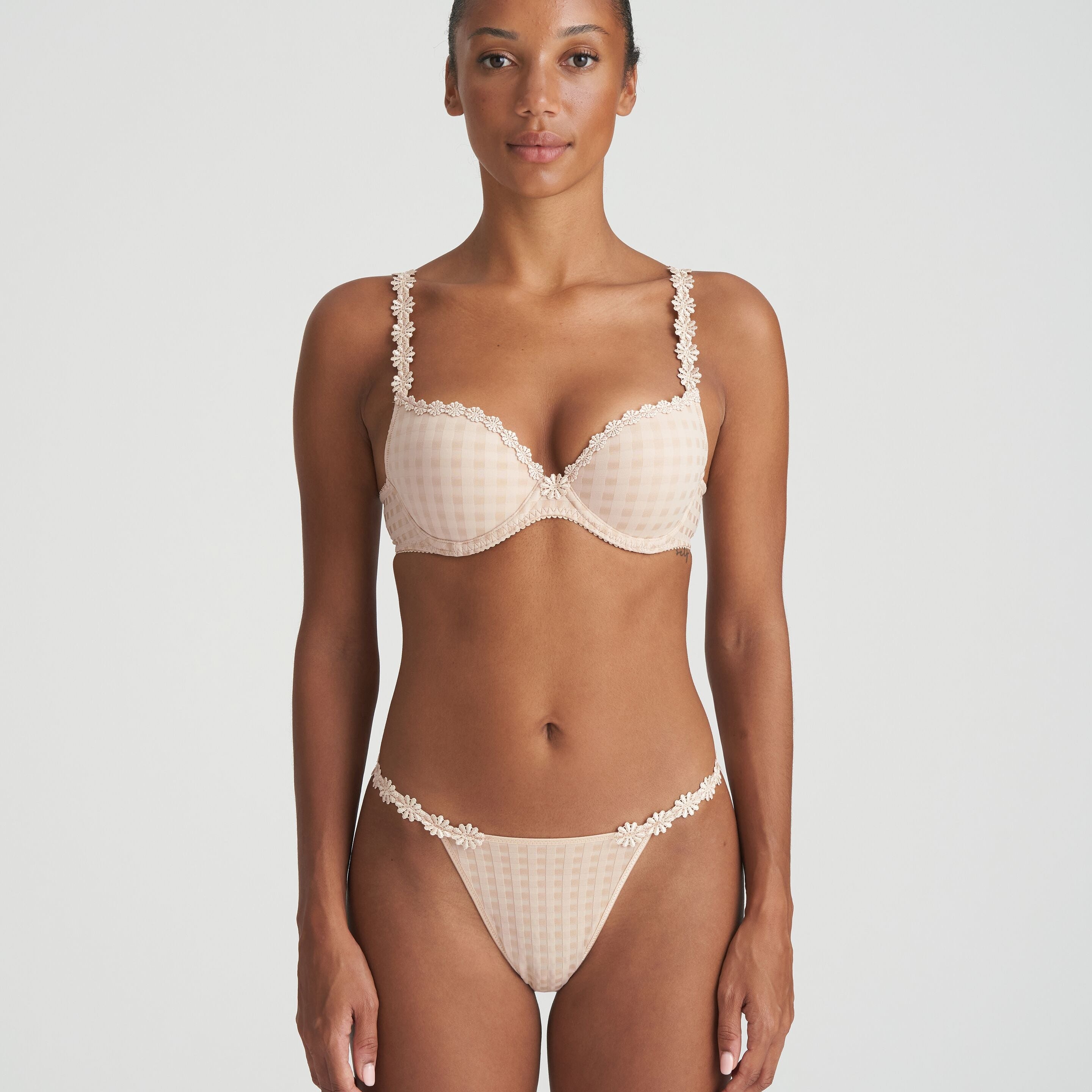 Neutral thong that is non transparent in front and features delicate floral embroidery soft waistband with matching bra.
