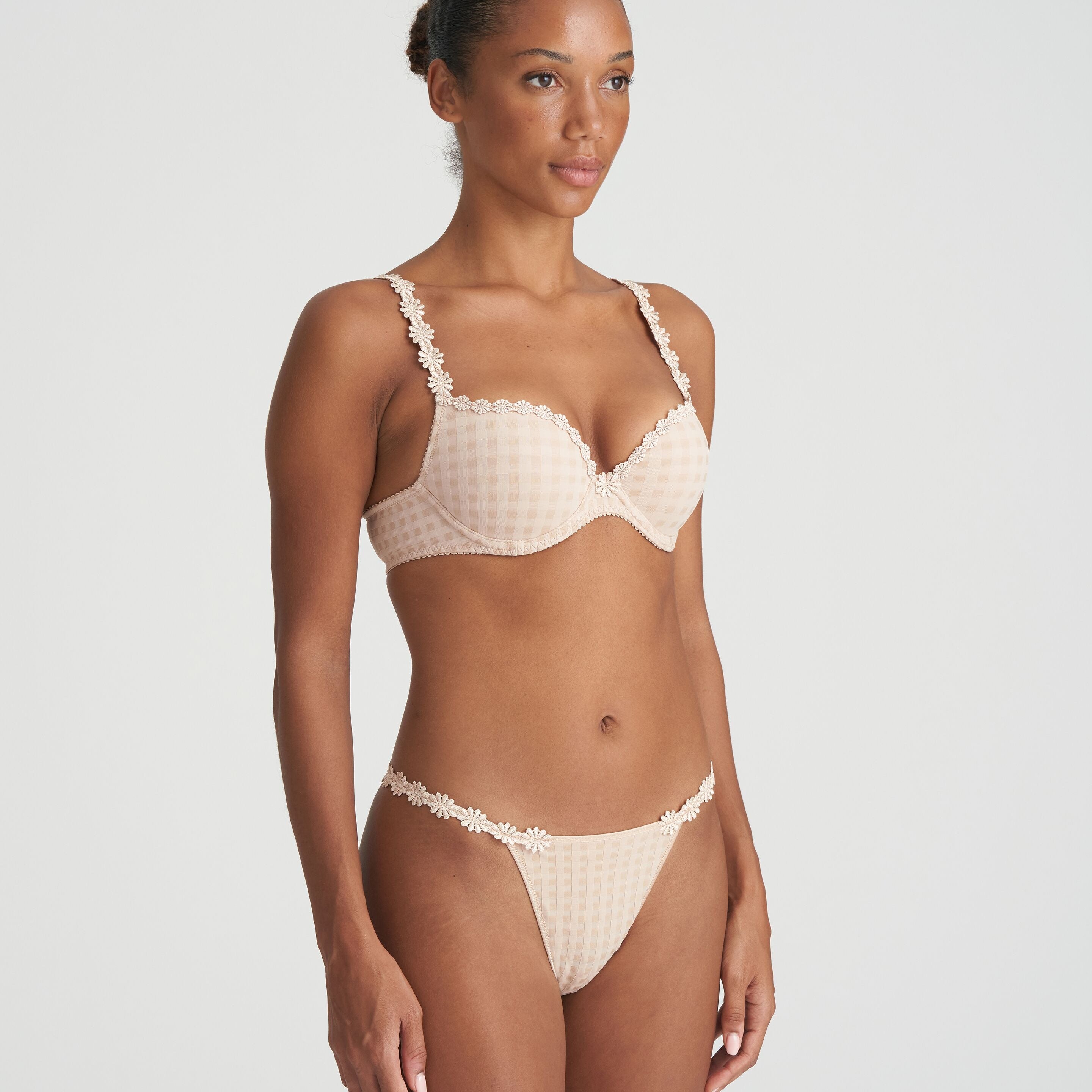 Neutral thong that is non transparent in front and features delicate floral embroidery soft waistband with matching bra.
