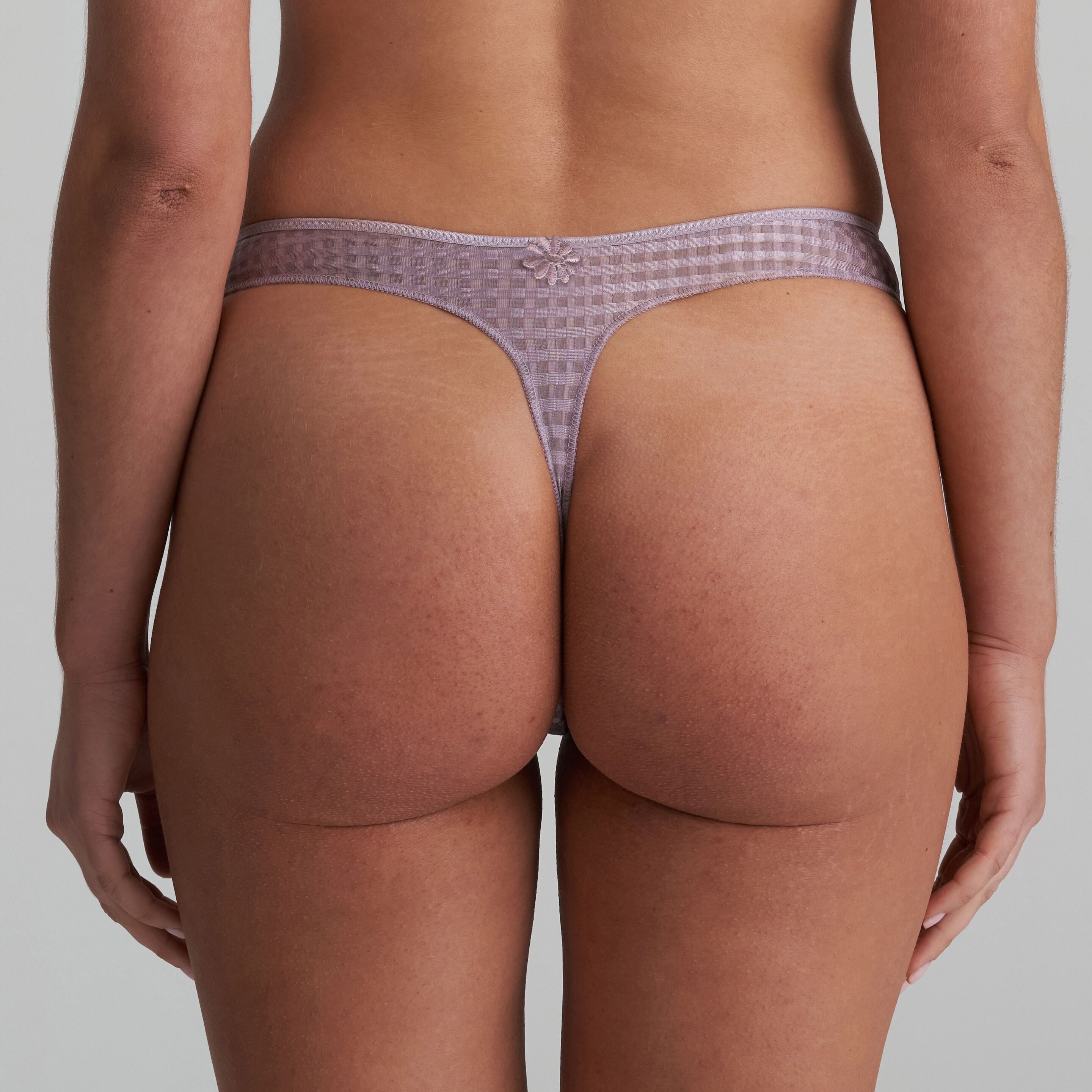 Thong in soft sand colour with little flower at back and shimmer to the fabric