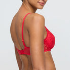 Red bra and panties set on a plain background