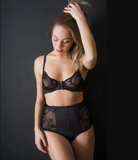 Black underwired bra with cups in elastic printed tulle for a transparent effect, front fastening, scuba trim and adjustable straps at the back